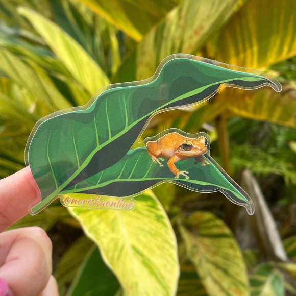 Sticker transparente de los campos de Puerto Rico con el coquí paseándose entre hojas de plátano. Diseñado en Puerto Rico por mujer empresaria. | Boricua clear sticker with a coqui frog and a plaintain plant from Puerto Rico